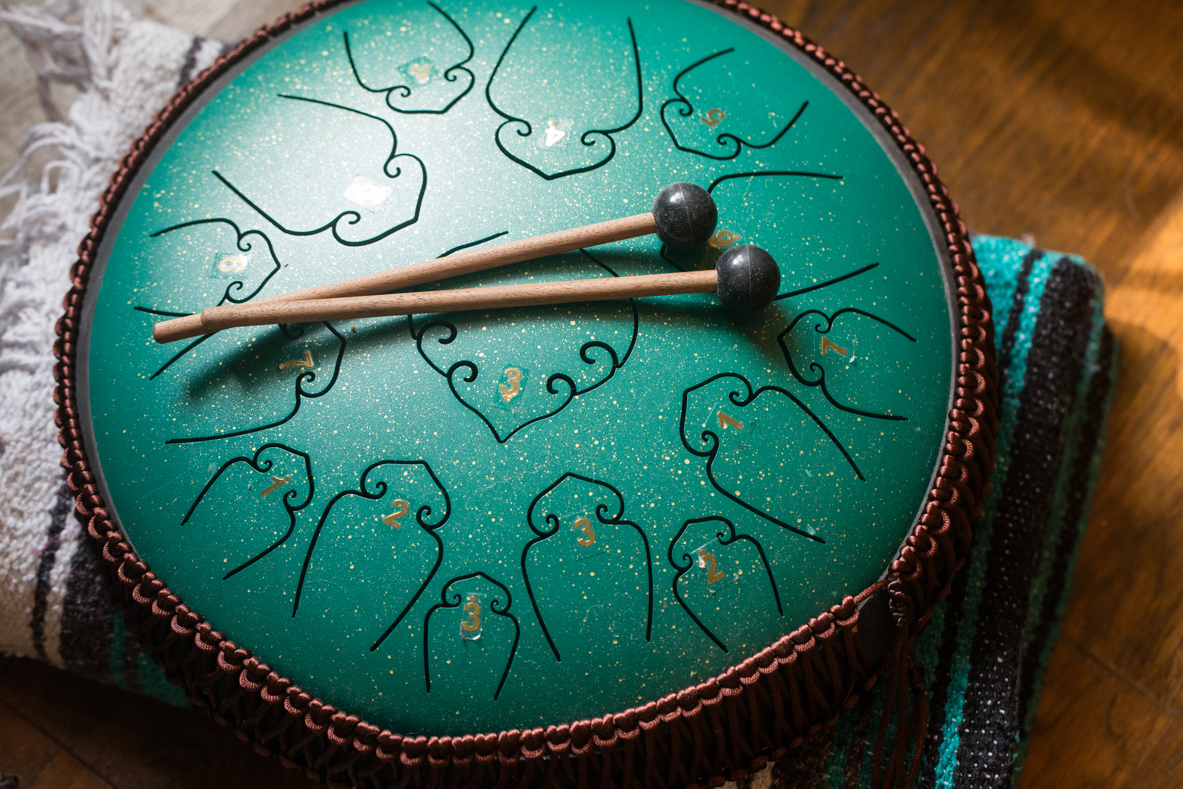Handpan and mallets on a blanket